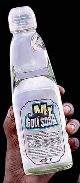 A hand holding a bottle of Lemon Mr. Goli Soda