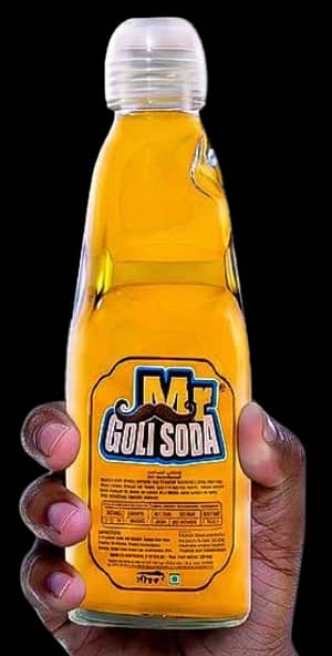 A hand holding a bottle of Pineapple Mr. Goli Soda